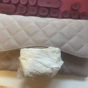 Quilted beige clutch can be worn with a chain strap or without